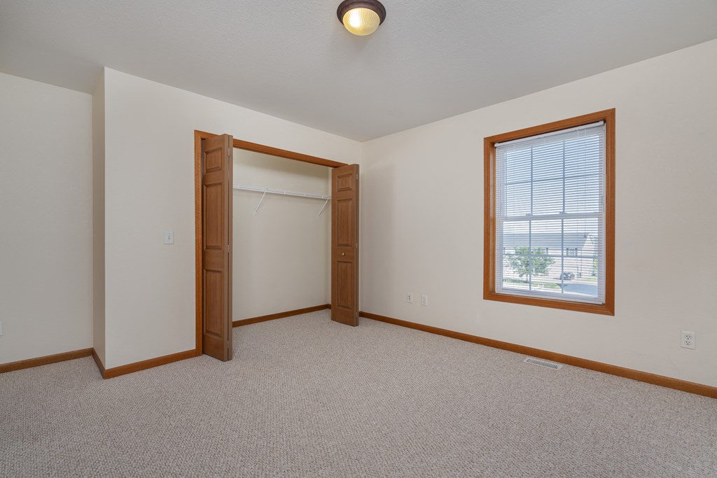 A room with a window and a door.