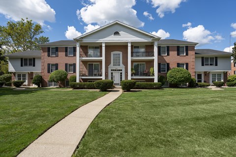 A large brick building with a white door and windows.