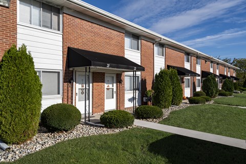 A row of houses with a white and red brick facade.