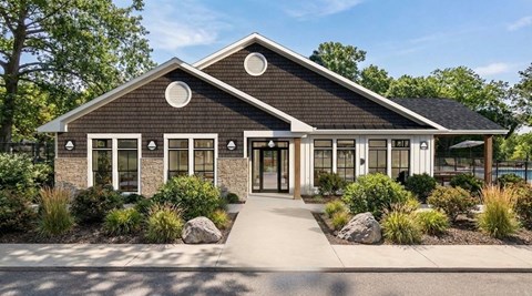 A modern house with a black roof and white trim.
