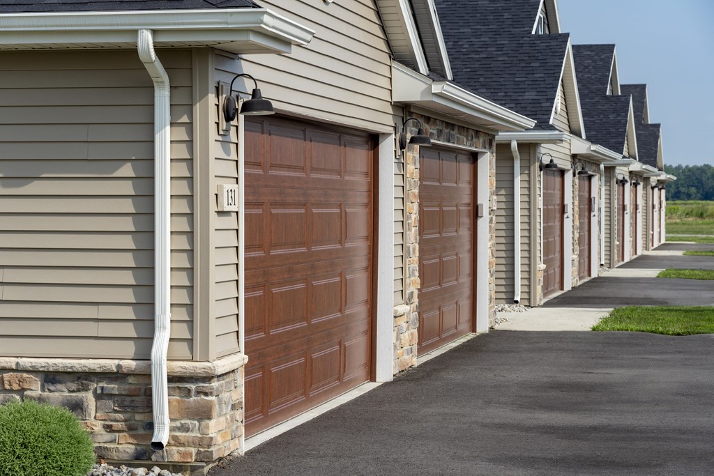 A long row of houses with garages on the side.