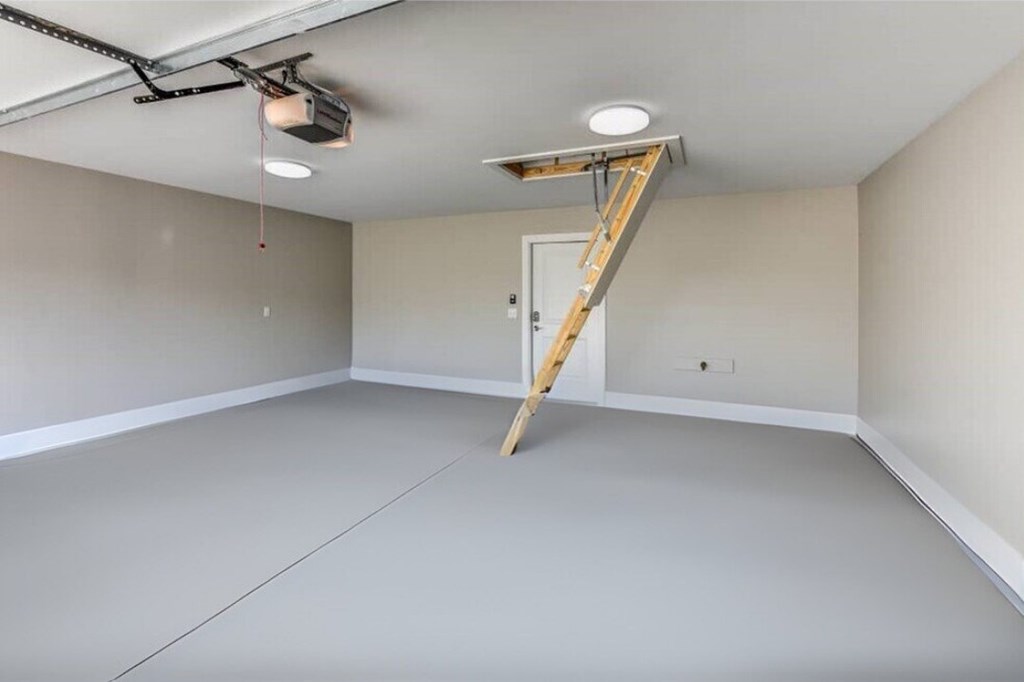 A room with a ladder and a light fixture on the ceiling.