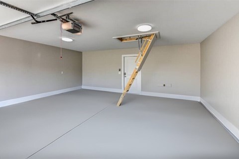 A room with a ladder and a light fixture on the ceiling.
