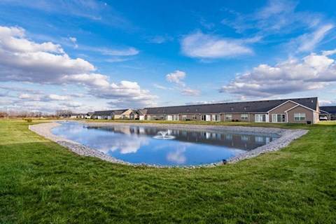 A large building with a pool in front of it.