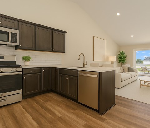 A modern kitchen with dark brown cabinets and a white brick backsplash.