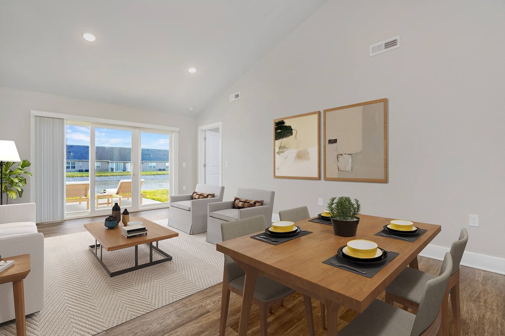 A modern dining room with a wooden table set for four.