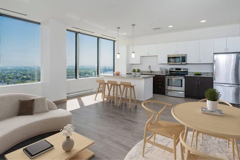 A modern kitchen with a dining table and chairs.
