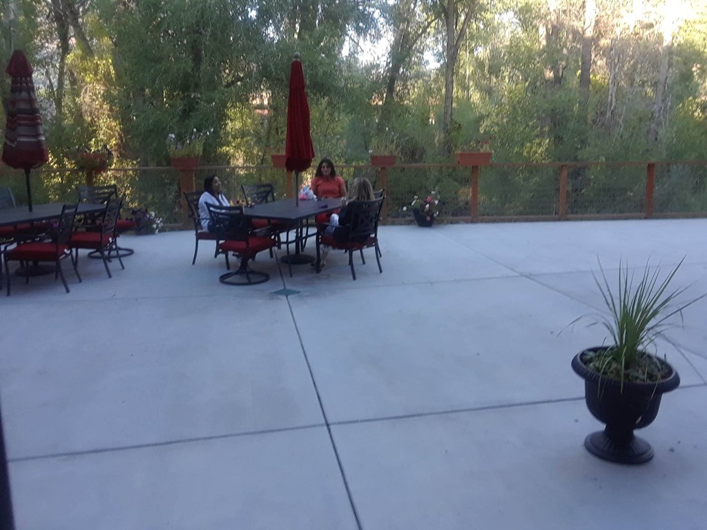 a patio with people sitting at a table  at Roaring Fork Apartments, Basalt, 81621