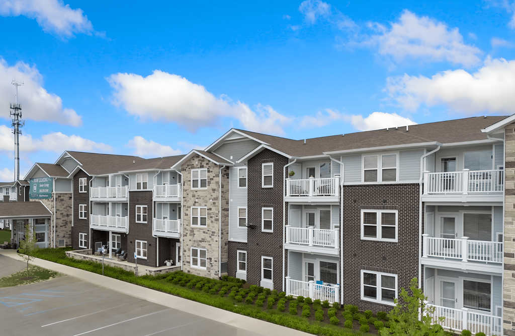 an exterior view of an apartment building on a street at 41 North Senior Living Apartments, Fort Wayne