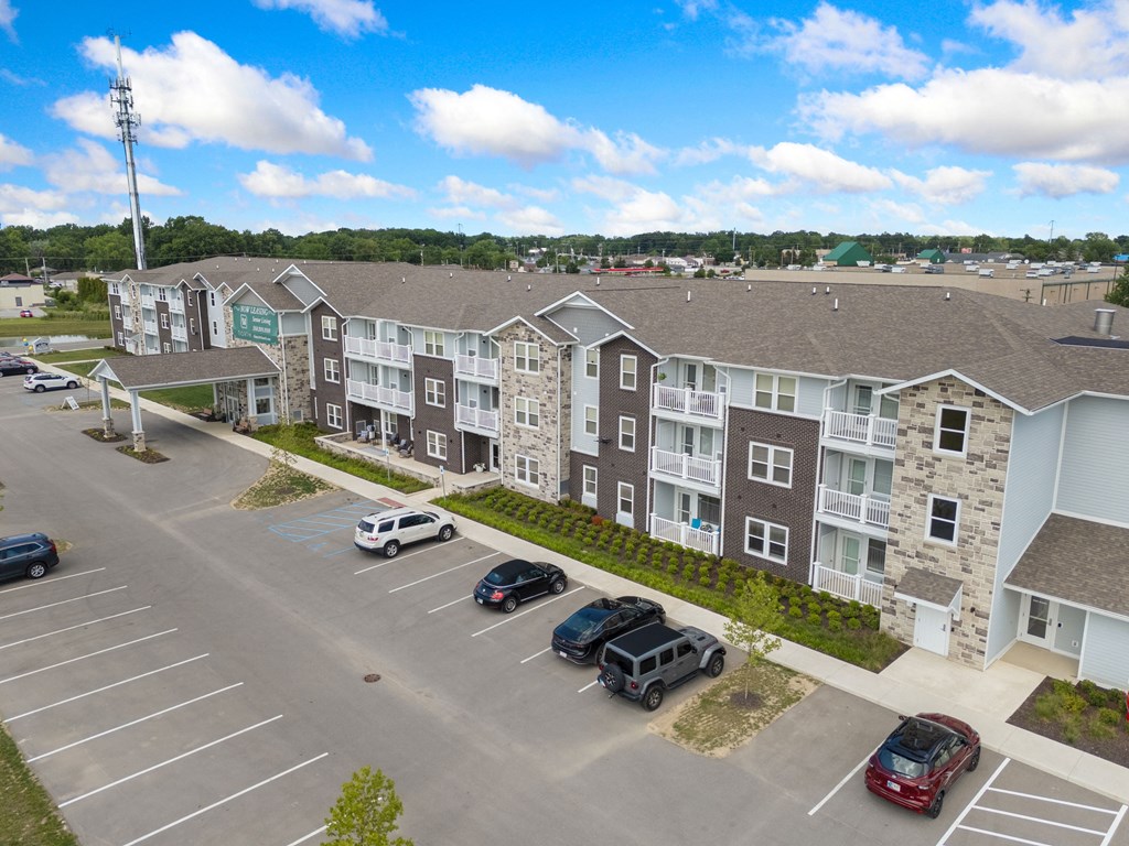 an aerial view of an apartment complex with cars parked in a parking lot at 41 North Apartments, Fort Wayne