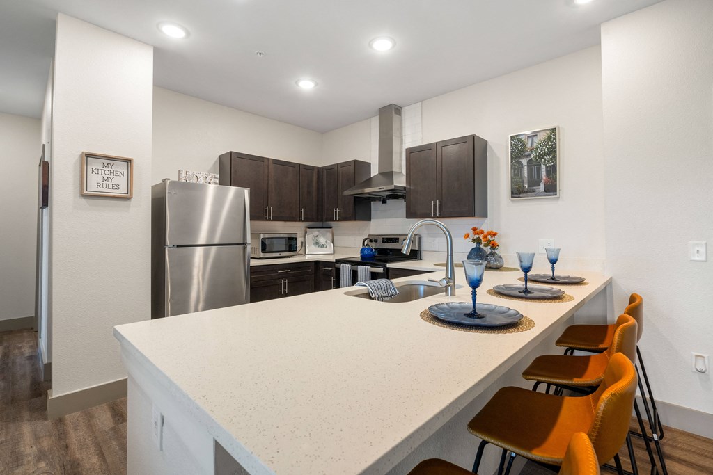 a kitchen with a large island and a stainless steel refrigerator at 41 North Apartments, Fort Wayne Indiana