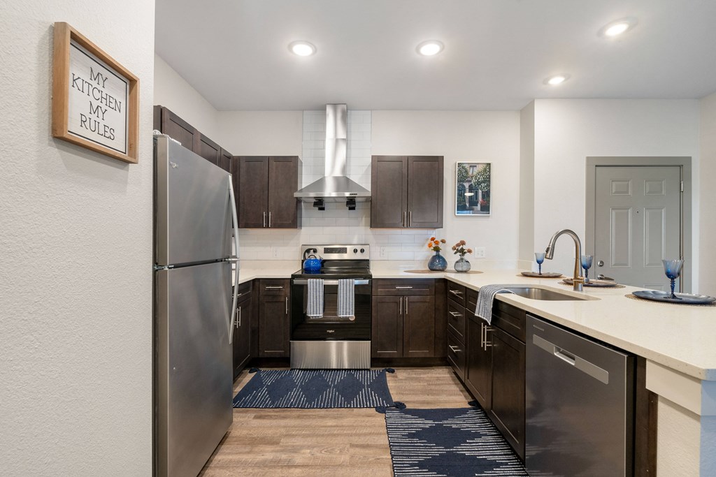 an open kitchen with stainless steel appliances and a refrigerator at 41 North Apartments, Fort Wayne
