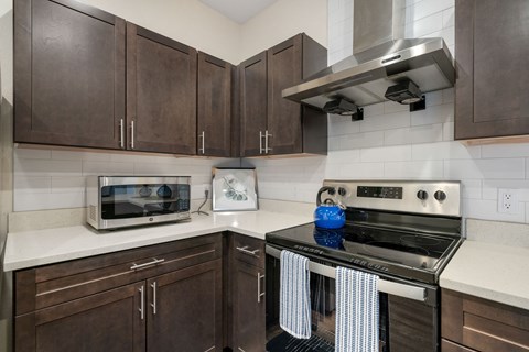 a kitchen with a stove top oven and a microwave