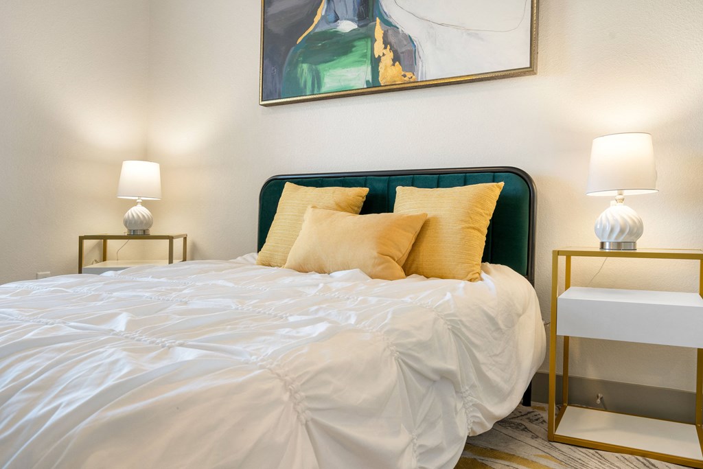 the master bedroom has a large bed and a painting on the wall at 41 North Apartments, Indiana