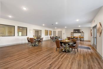 a large community room with a dining room table and chairs at 41 North Senior Living Apartments, Indiana