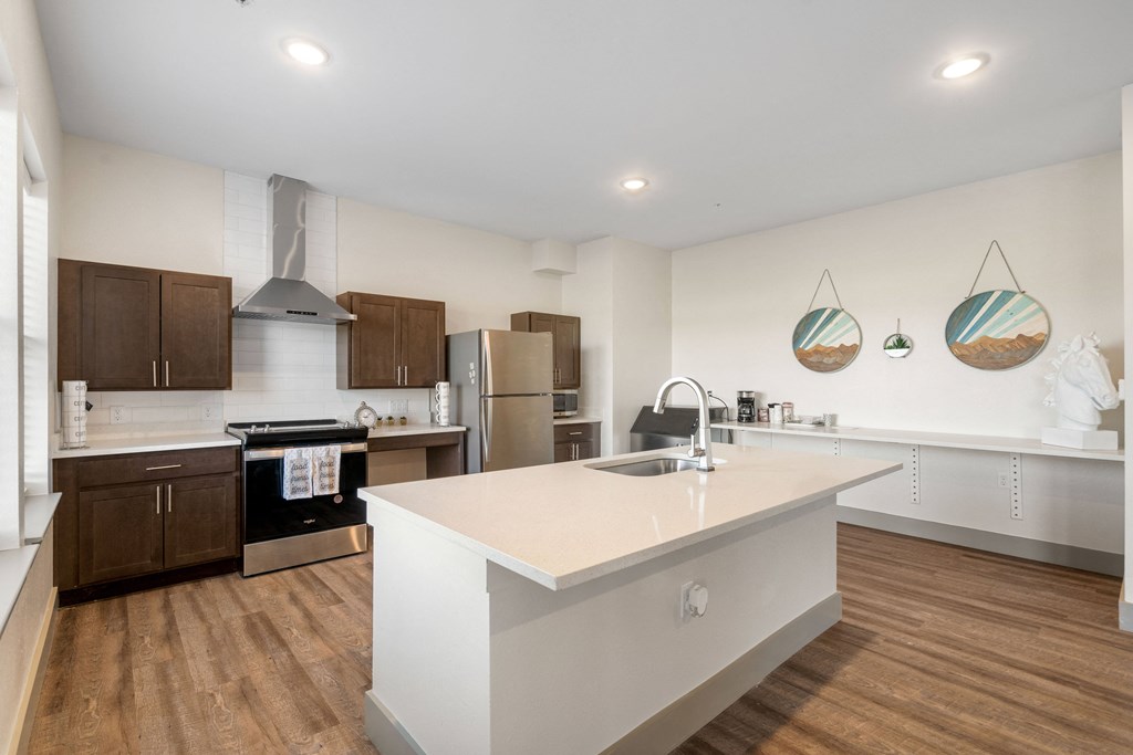 a large white kitchen with a large island and stainless steel appliances at 41 North Apartments, Fort Wayne, IN 46835