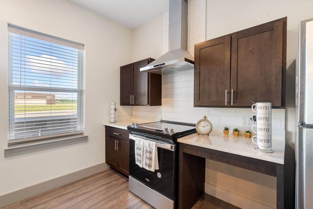 an updated kitchen with black appliances and wooden cabinets at 41 North Apartments, Fort Wayne, IN 46835