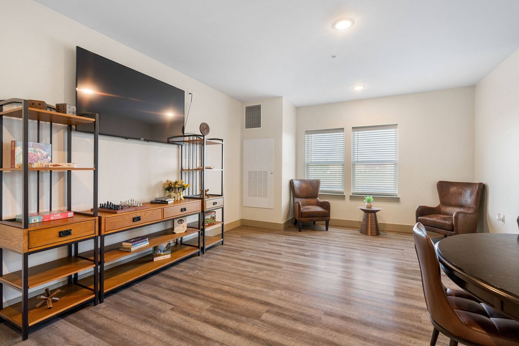 a living room with a tv and a table and chairs at 41 North Apartments, Fort Wayne, 46835