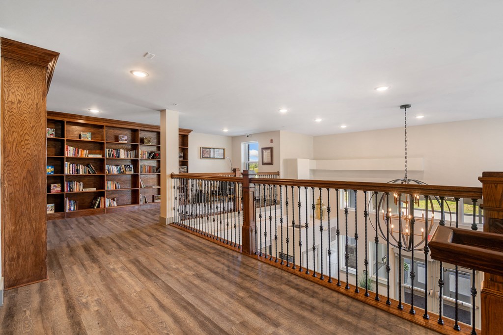 a living room with a staircase and a bookshelf at 41 North Apartments, Indiana
