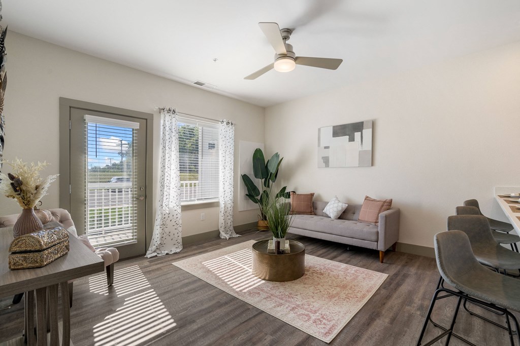 an open living room and dining room with a ceiling fan and sliding glass doors at 41 North Apartments, Fort Wayne Indiana