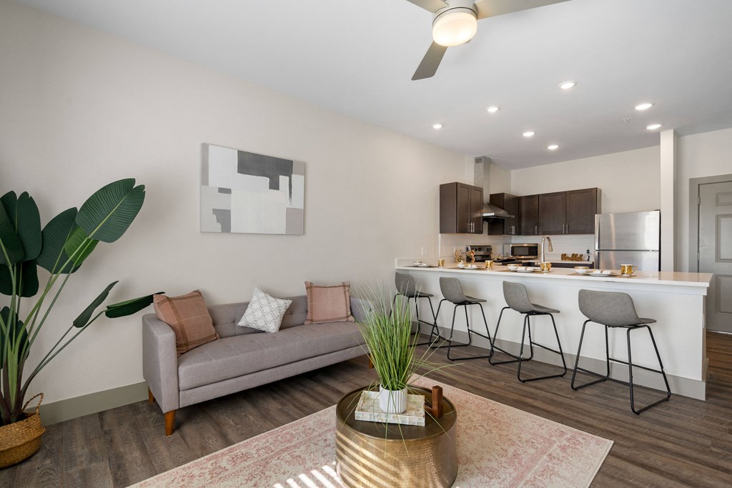 a living room with a couch and a kitchen with a bar at 41 North Apartments, Indiana, 46835