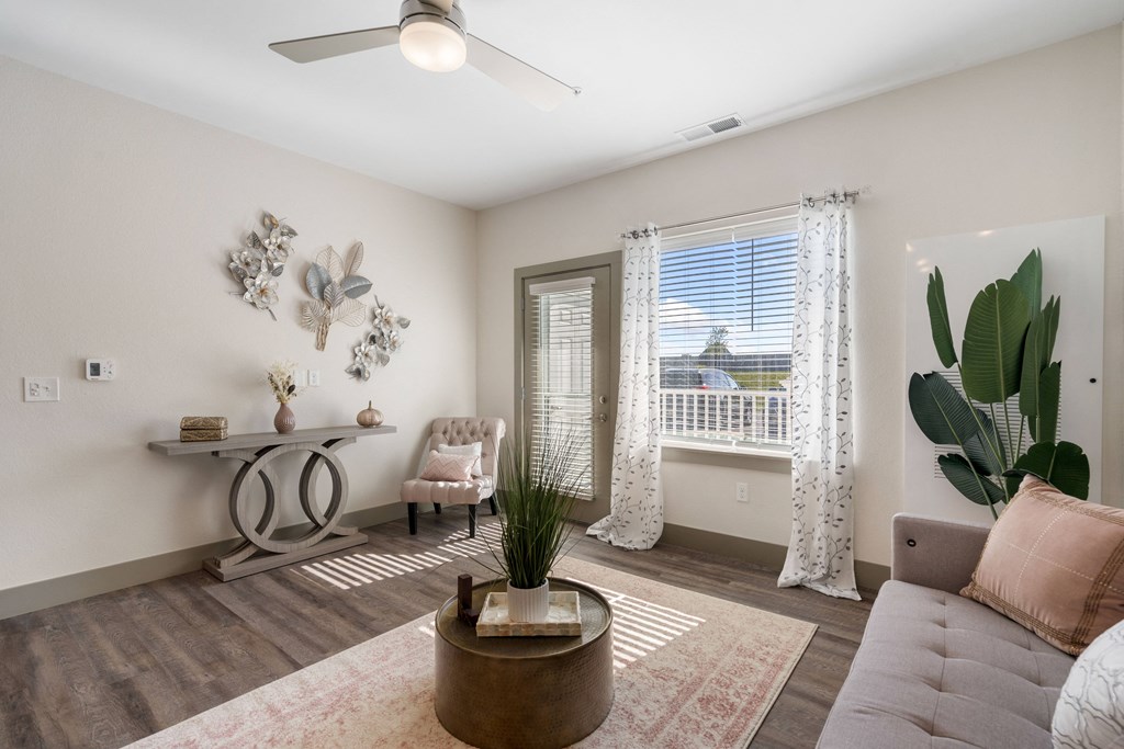 a living room with a couch and a chair and a window at 41 North Apartments, Fort Wayne, 46835