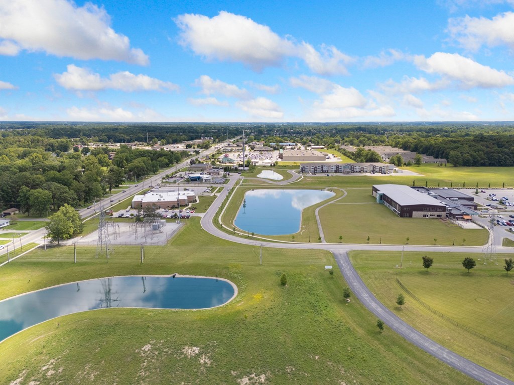an aerial view of a park with a pond and buildings at 41 North Apartments, Indiana