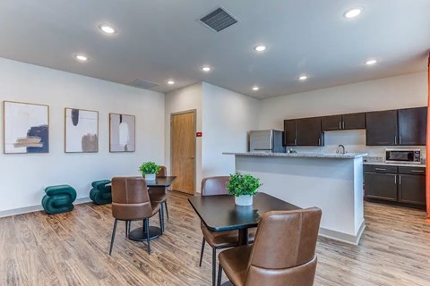 A modern kitchen with a dining table and chairs.