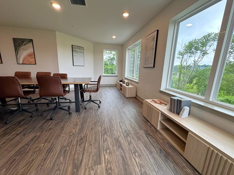 A conference room with a long table and chairs.
