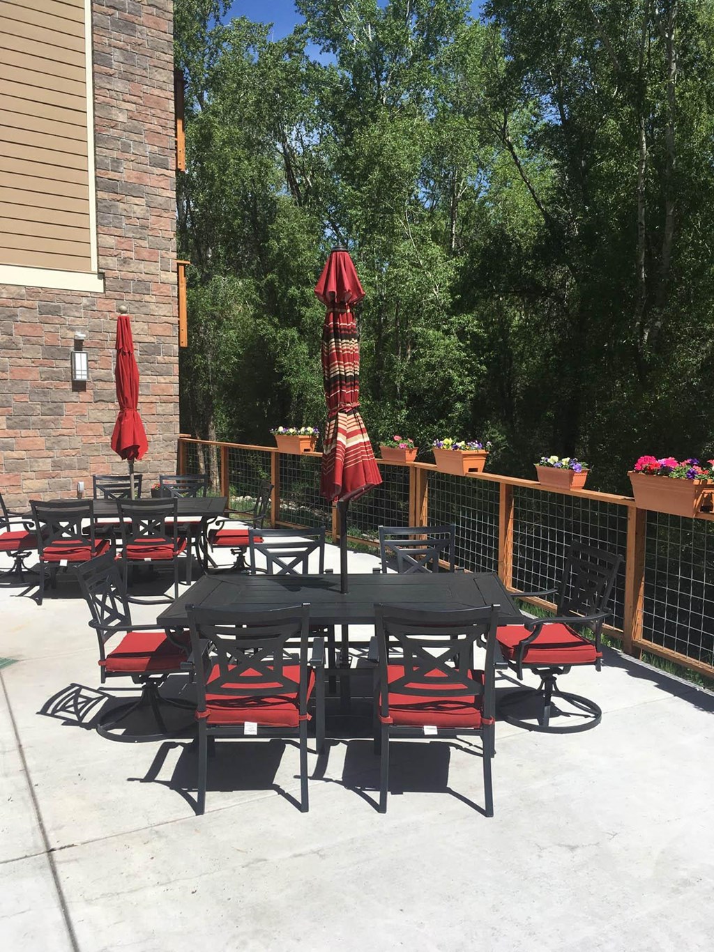 the patio is full of tables and umbrellas  at Roaring Fork Apartments, Basalt, CO, 81621