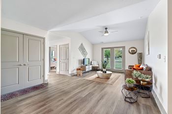 a living room with white walls and a ceiling fan at Morada at Maysville Apartments, Fort Wayne, Indiana