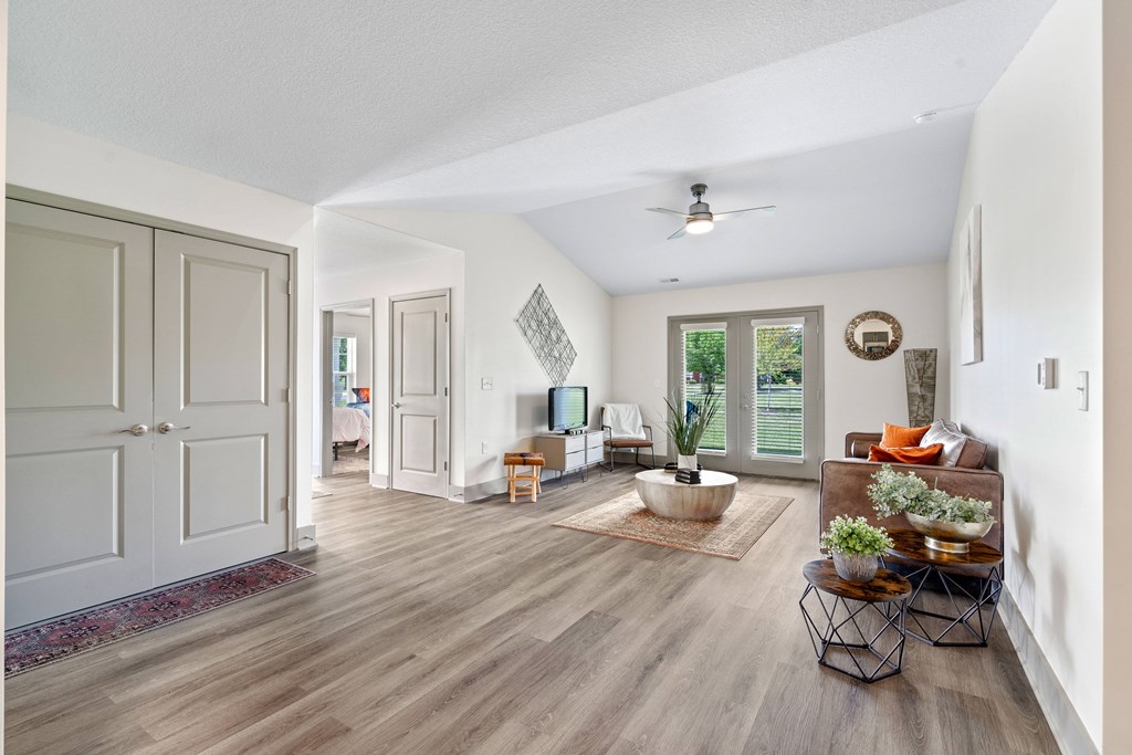 a living room with white walls and a ceiling fan at Morada at Maysville, Indiana