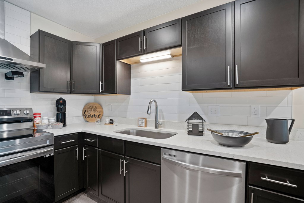 full kitchen with black cabinets and stainless steel appliances in downtown at Morada at Maysville, Indiana, 46815