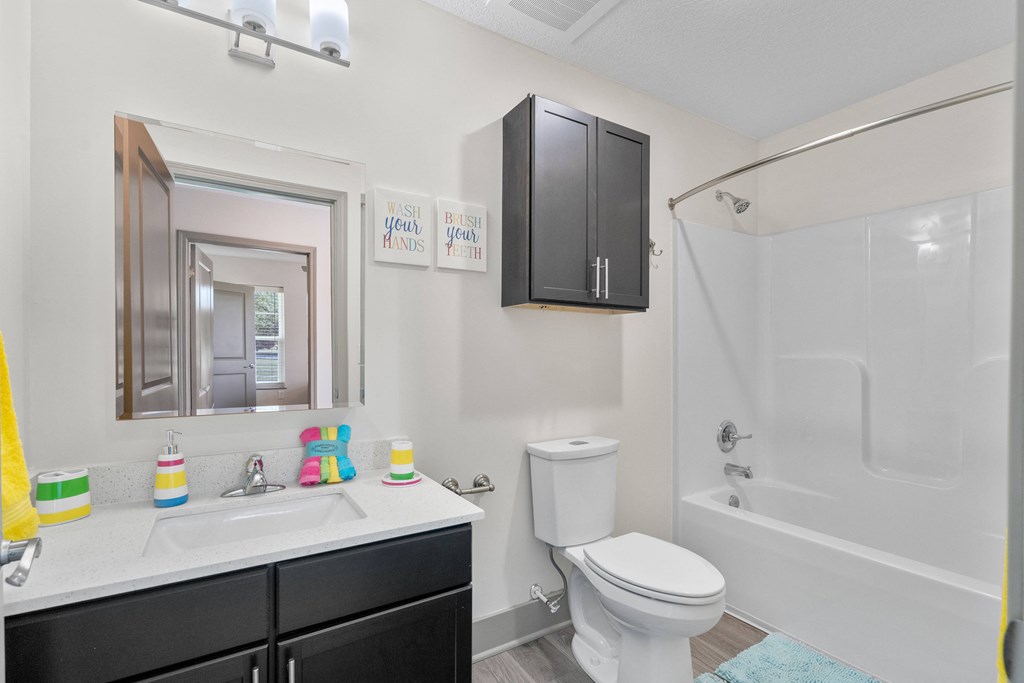 a bathroom with a sink toilet and shower and a mirror at Morada at Maysville, Indiana, 46815
