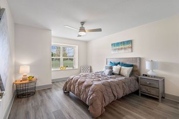 a bedroom with a bed and a ceiling fan at Morada at Maysville Apartments, Fort Wayne