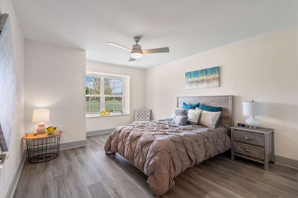 a bedroom with a bed and a ceiling fan a bedroom with a bed and a ceiling fan at Morada at Maysville, Fort Wayne, IN