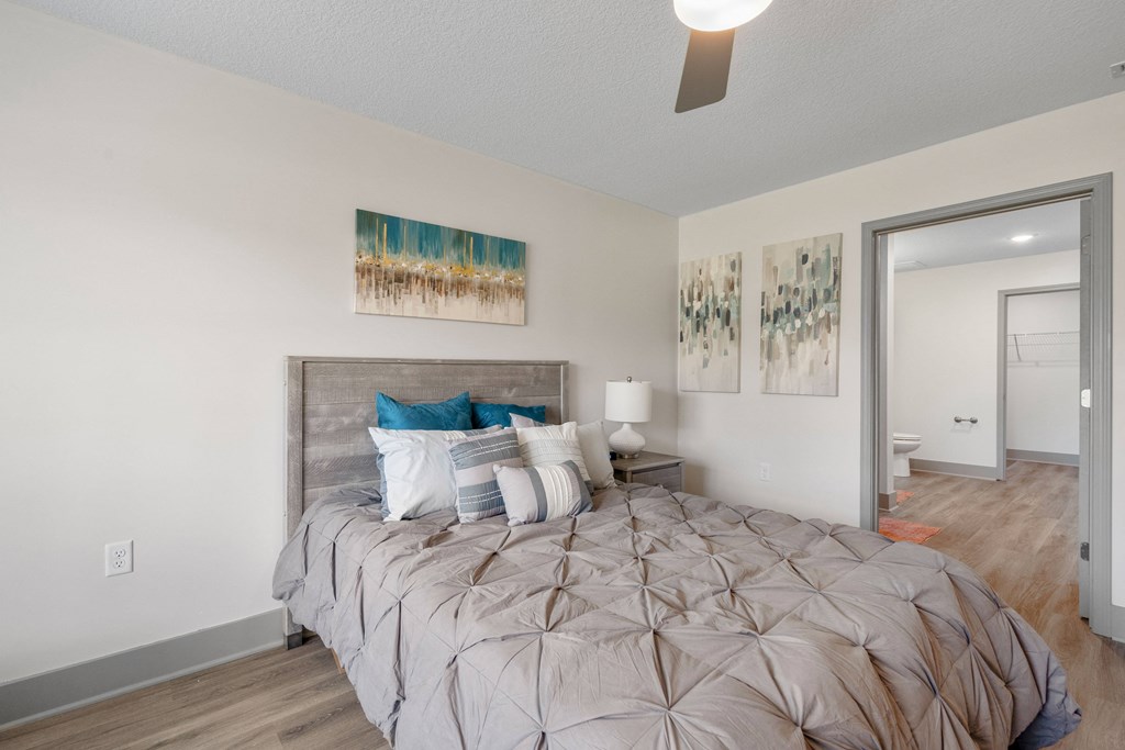 a bedroom with a large bed and a ceiling fan at Morada at Maysville, Fort Wayne, IN