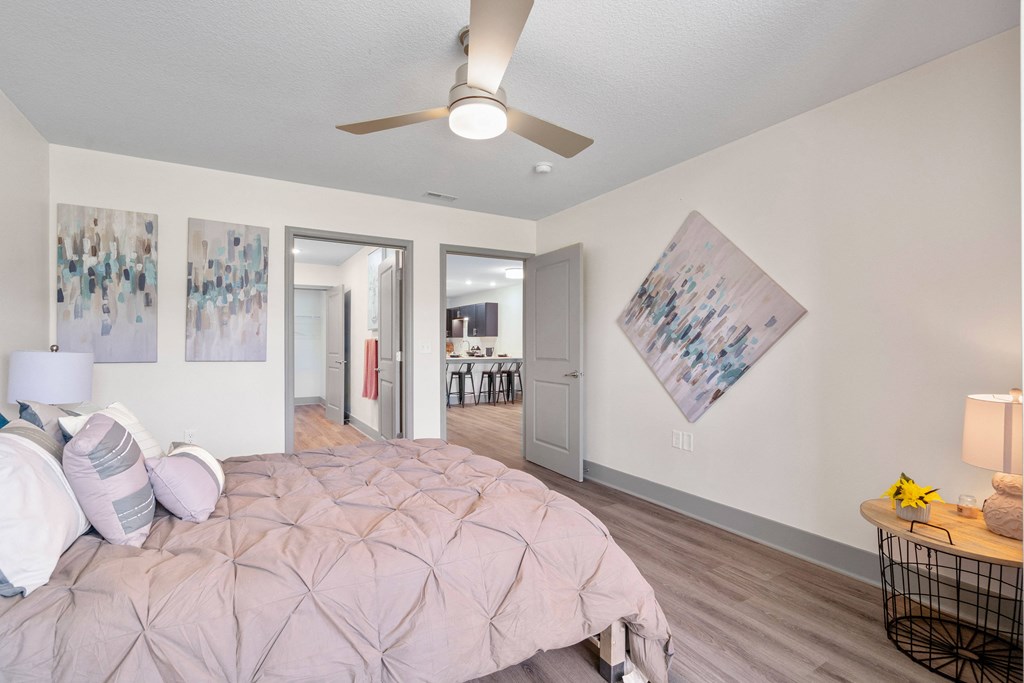 a bedroom with a large bed and a ceiling fan at Morada at Maysville, Fort Wayne, IN