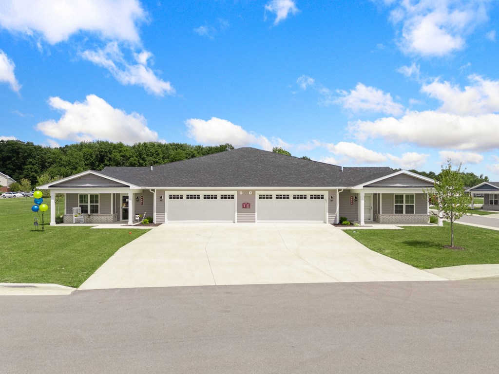 the front of a house with a driveway and lawn at Morada at Maysville, Indiana, 46815
