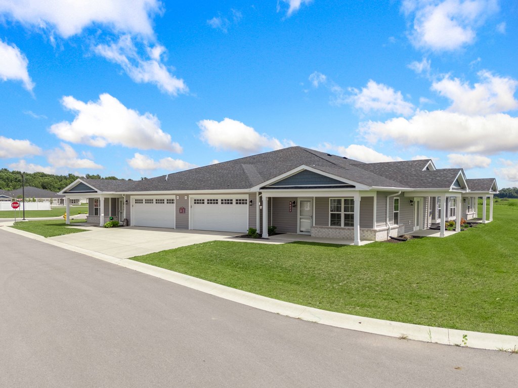 a house with a driveway and lawn in front of it at Morada at Maysville, Indiana