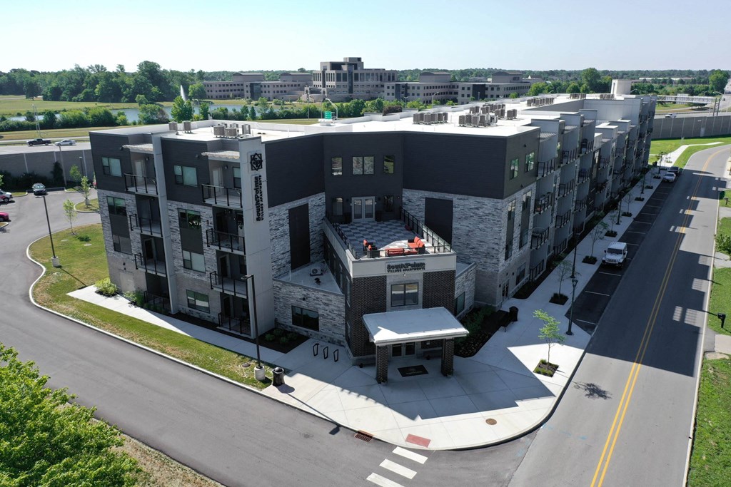 an aerial view of an apartment building with a parking lot at SouthPointe Village Apartments, LP, Fishers