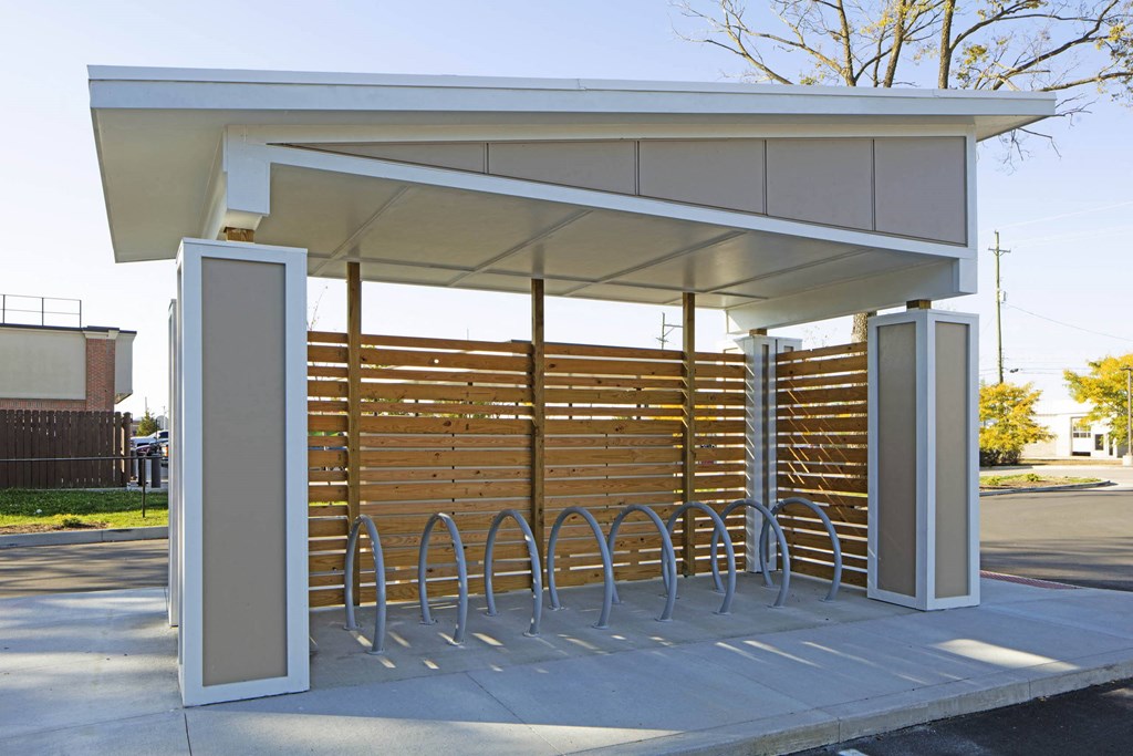 a bus stop with metal benches and awning  at Gladstone Apartments, Columbus, IN, 47201