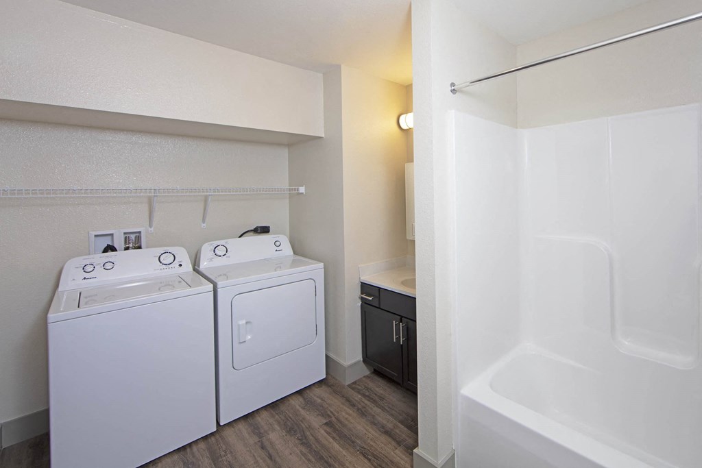 a white washer and dryer in a room with a sink and a tub at Gladstone Apartments, Columbus, IN, 47201