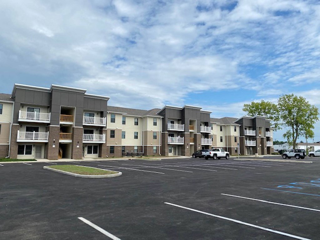 an empty parking lot in front of an apartment building at Gladstone Apartments, Columbus, IN, 47201