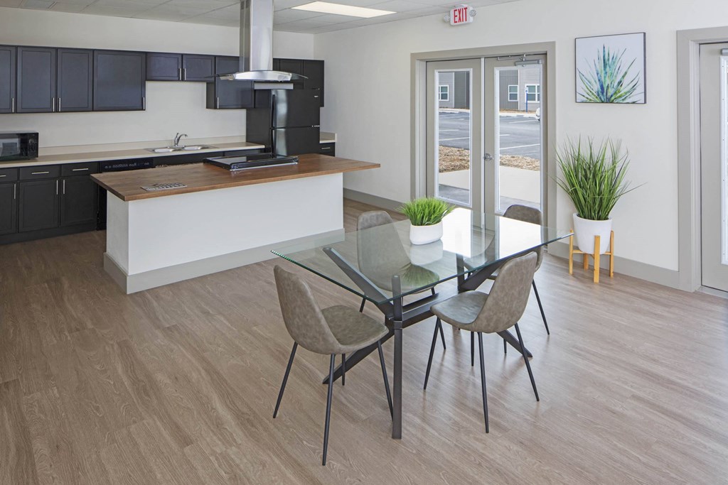 a dining room with a glass table and chairs