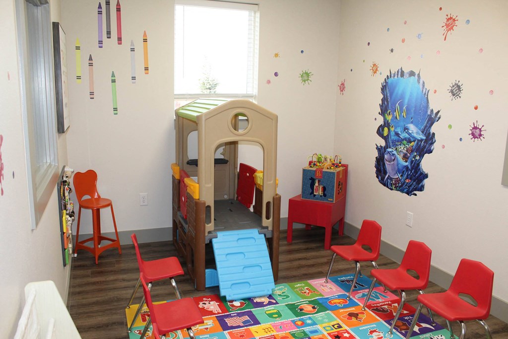 a childs play room with a play bed and chairs  at Haven Homes Apartments, LP, Plainfield, 46168