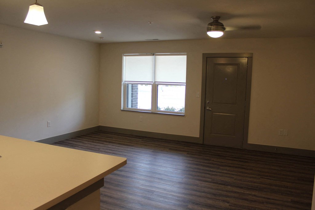 an empty living room with a window and a door  at Haven Homes Apartments, LP, Plainfield, IN, 46168