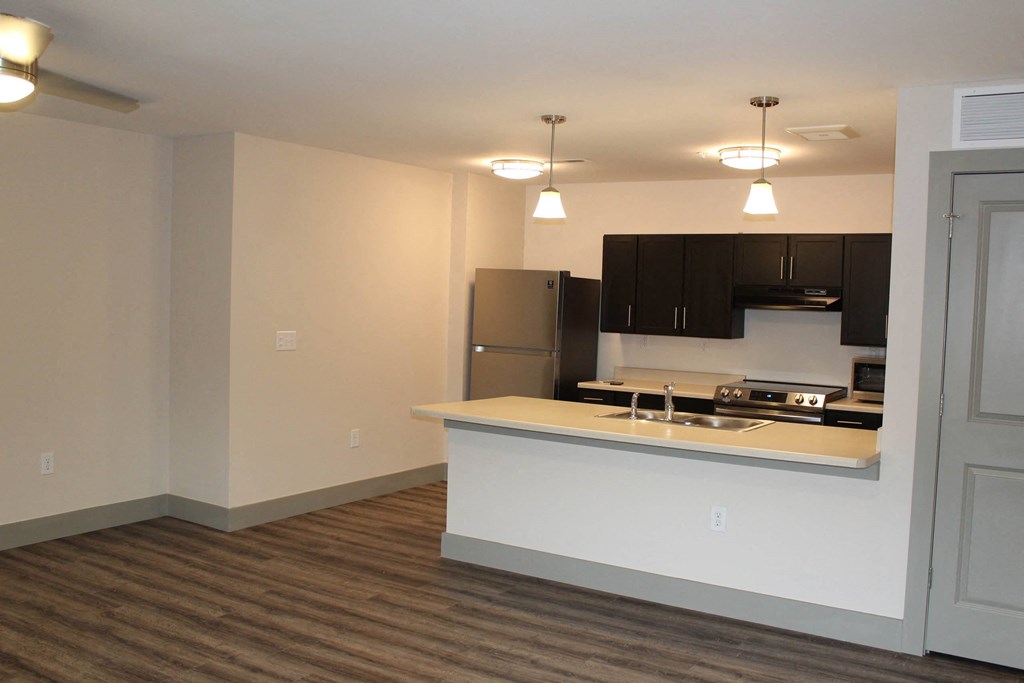a kitchen with a counter top and a refrigerator  at Haven Homes Apartments, LP, Indiana