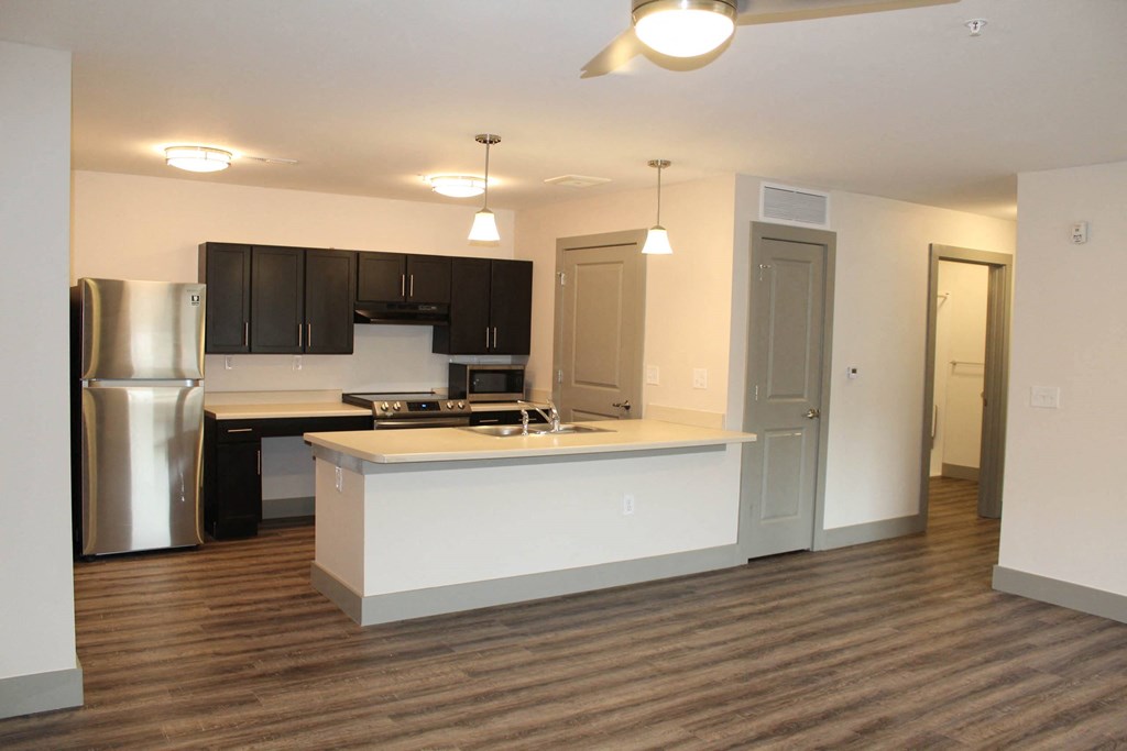 a kitchen with a counter top and a refrigerator  at Haven Homes Apartments, LP, Indiana
