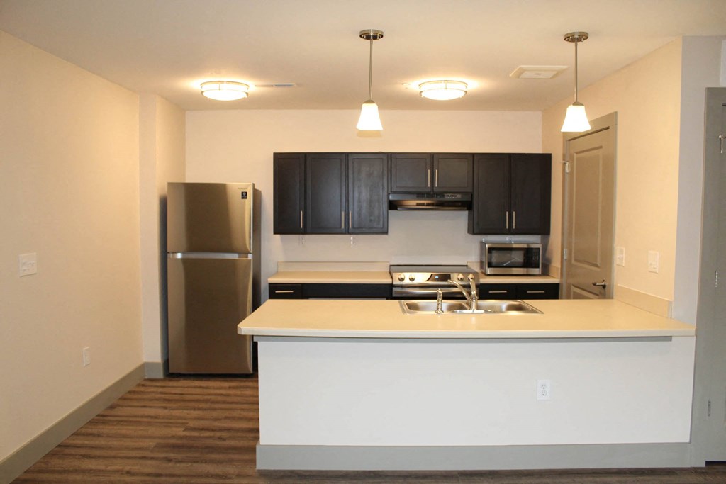 a kitchen with black cabinets and a stainless steel refrigerator  at Haven Homes Apartments, LP, Plainfield, 46168
